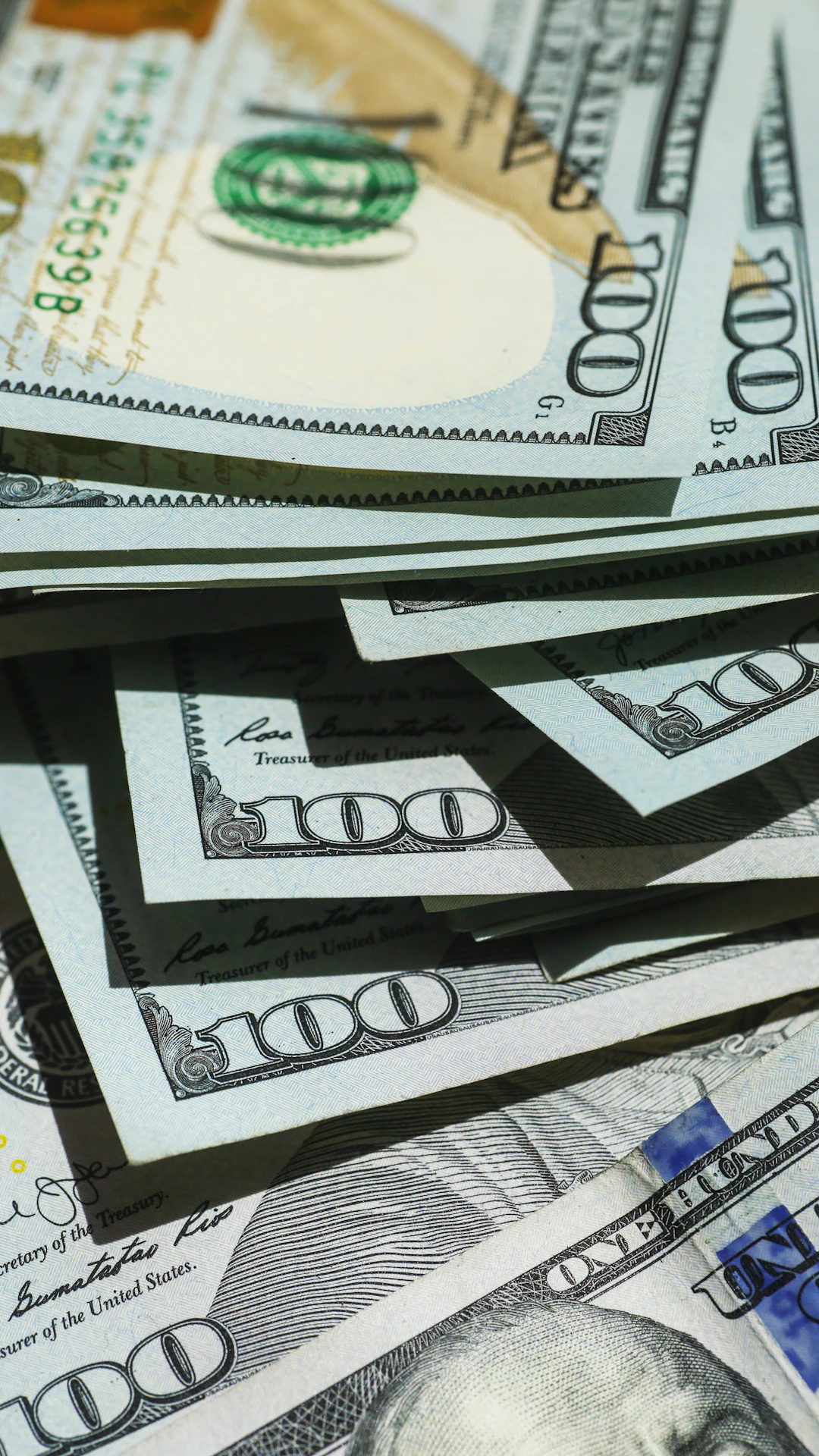 close up of stacked hundred dollar bills
