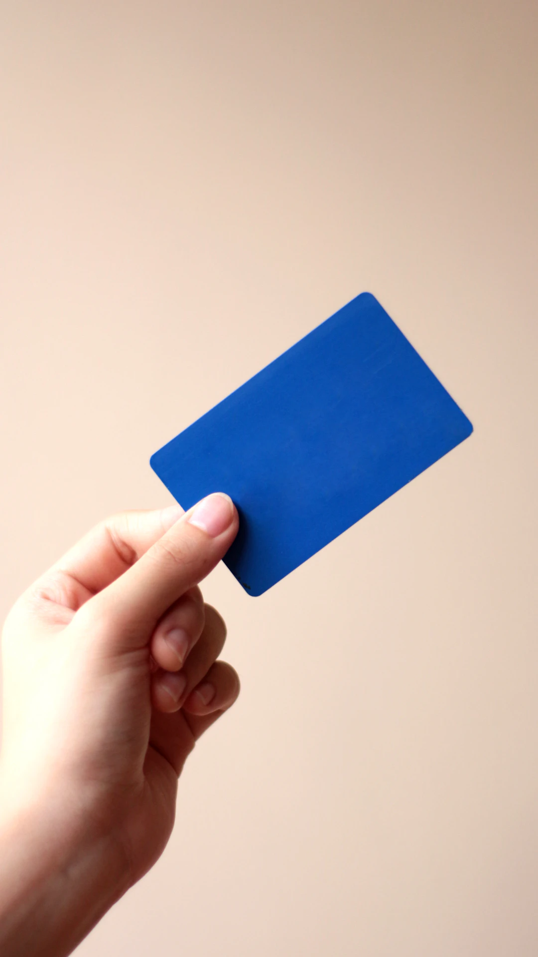 person holding blue card with white background