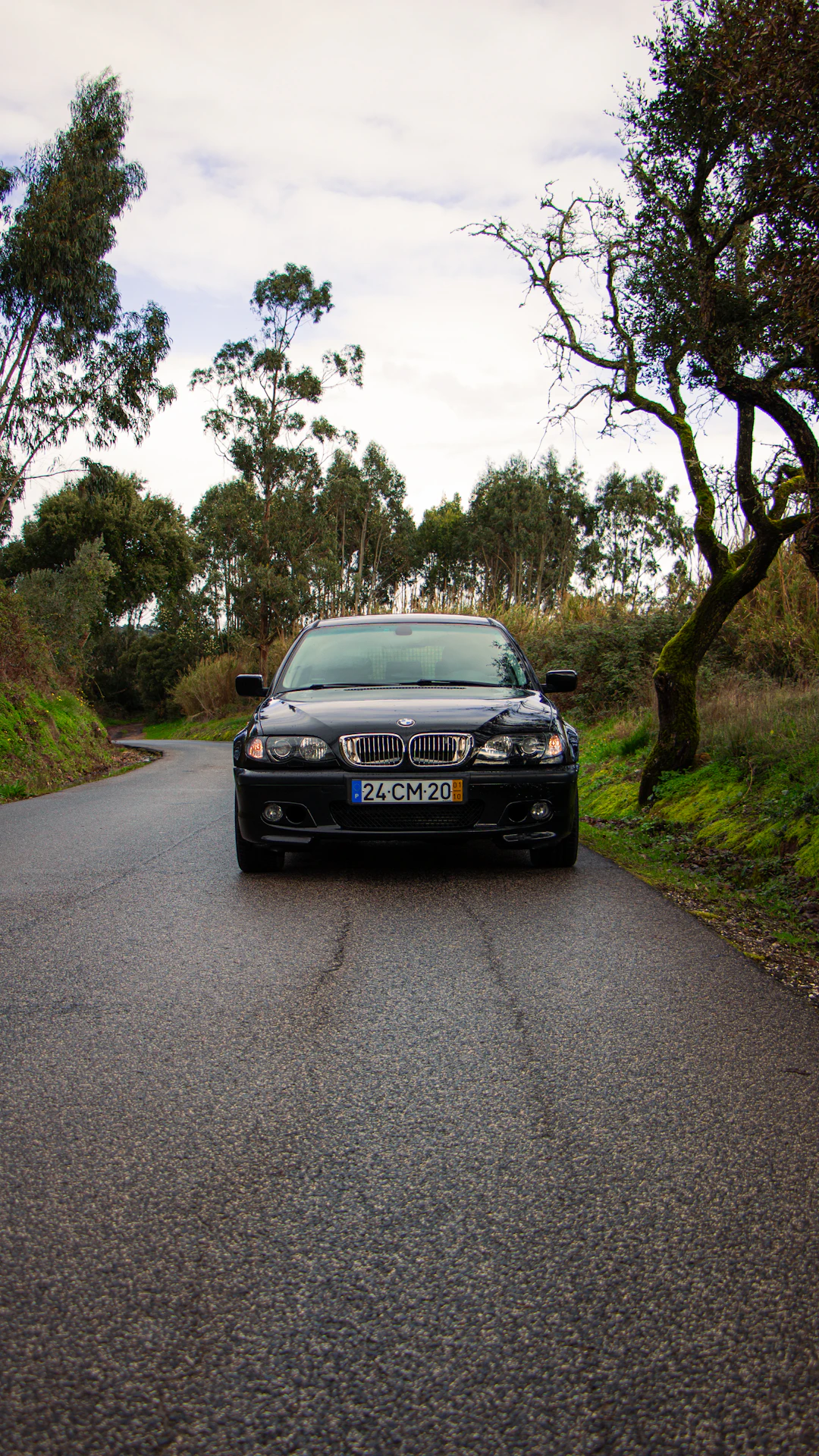 A black car parked on a wet road