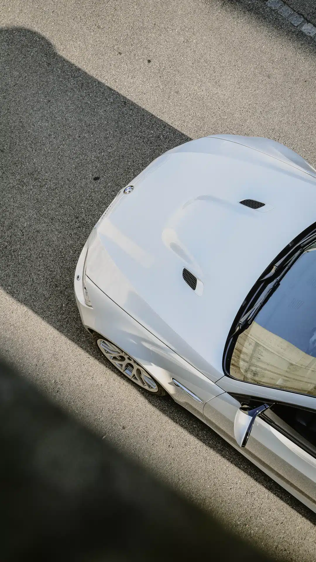 White sports car parked on asphalt road
