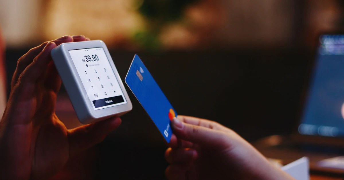 a person holding a credit card and a cell phone