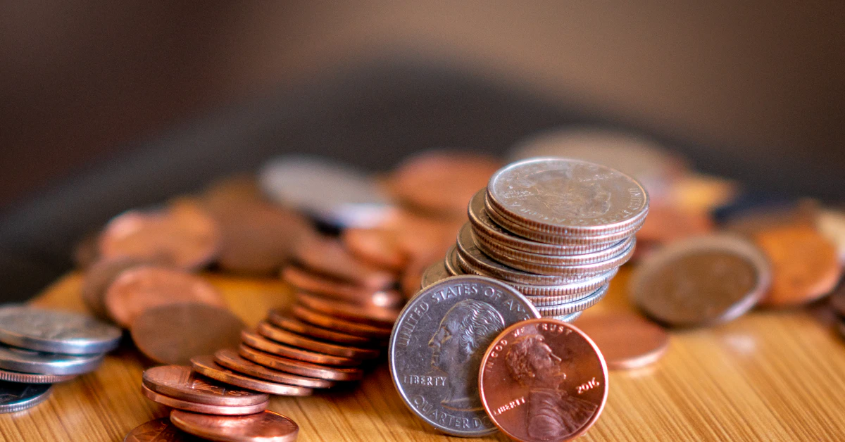 silver and gold coins on brown wooden table